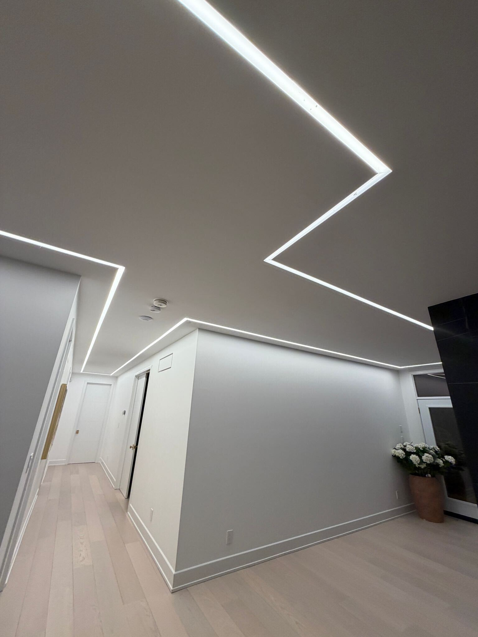 Another angle of hallway LED strip lighting with angular ceiling-to-wall pattern