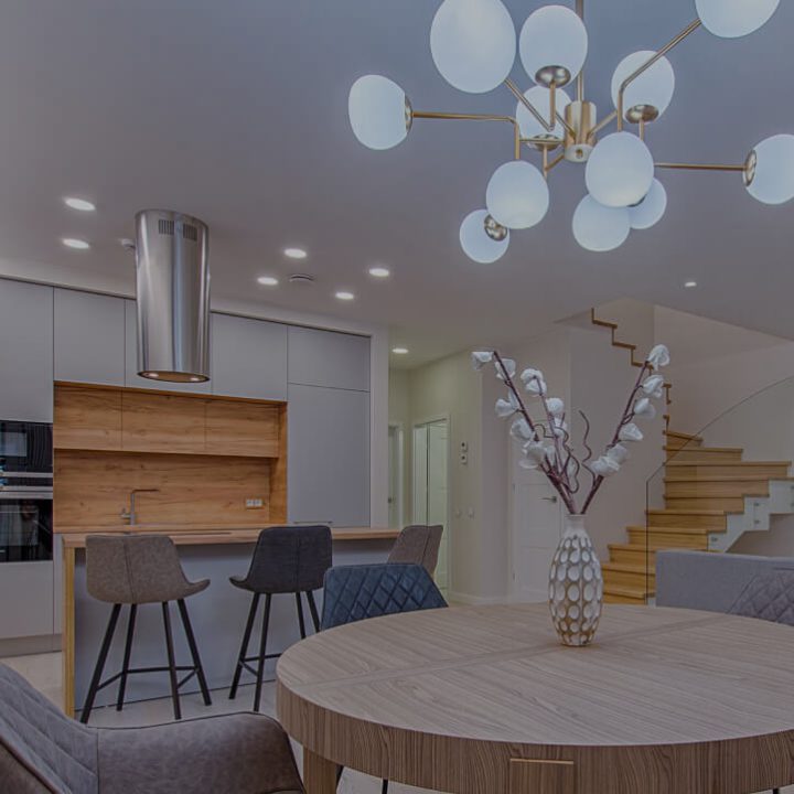 Kitchen with feature chandelier, pot lights and a stainless steel range hood